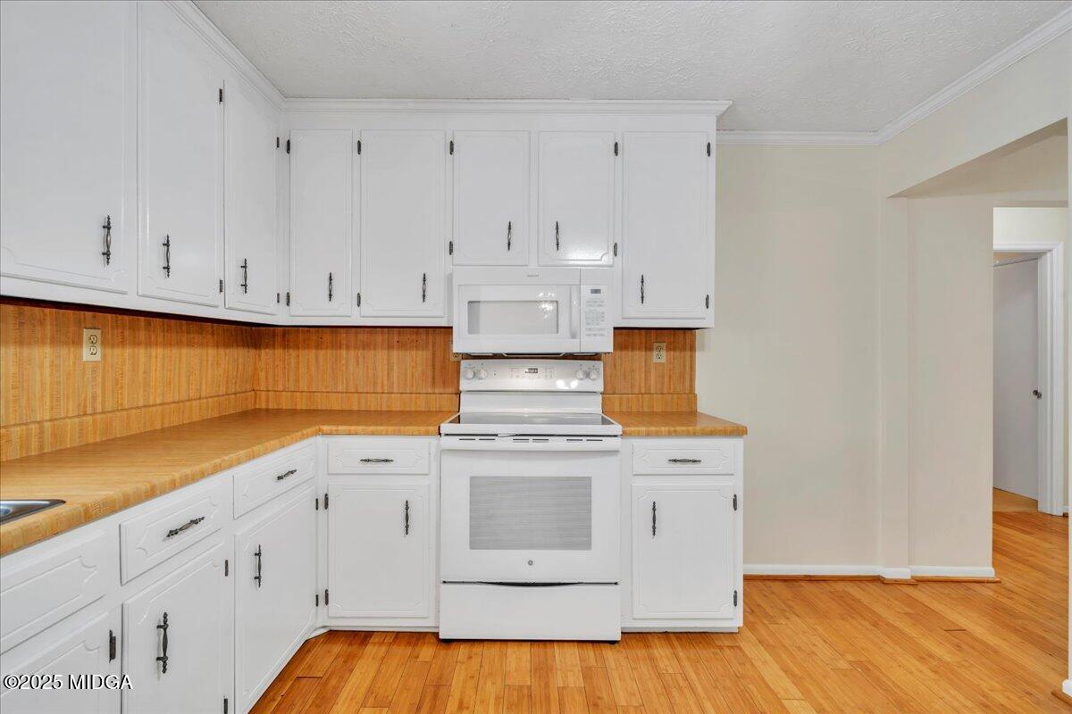 41 Golden Eye Monticello, GA 31064 - Photo 19 of 65 a kitchen with stainless steel appliances granite countertop a stove a sink and white cabinets
