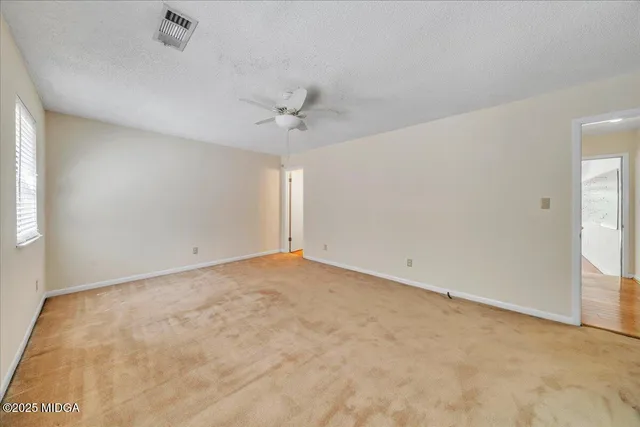 a view of staircase with white walls
