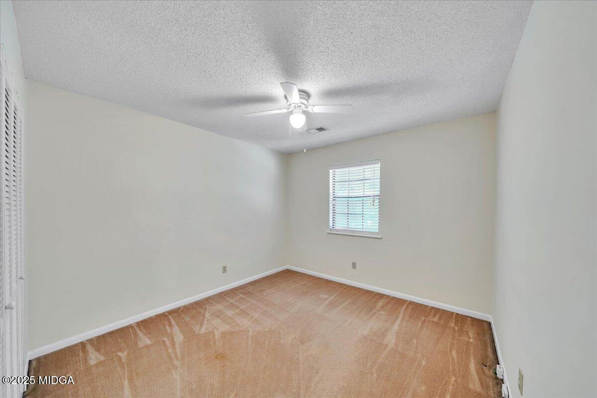 41 Golden Eye Monticello, GA 31064 - Photo 27 of 65 an empty room with a window and a ceiling fan
