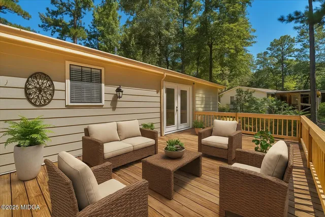 a balcony with furniture and a potted plant