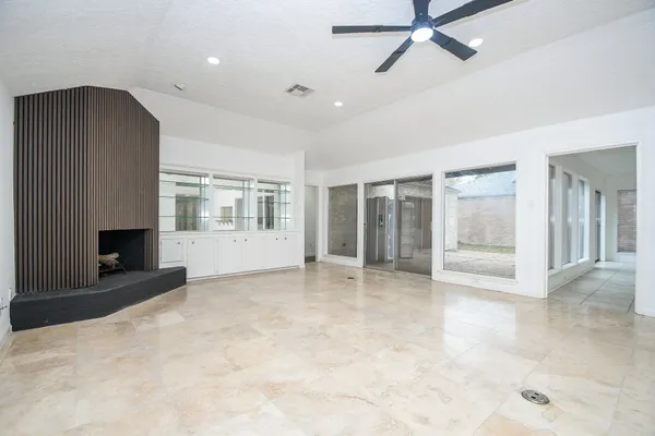 a view of an empty room with a fireplace and a window