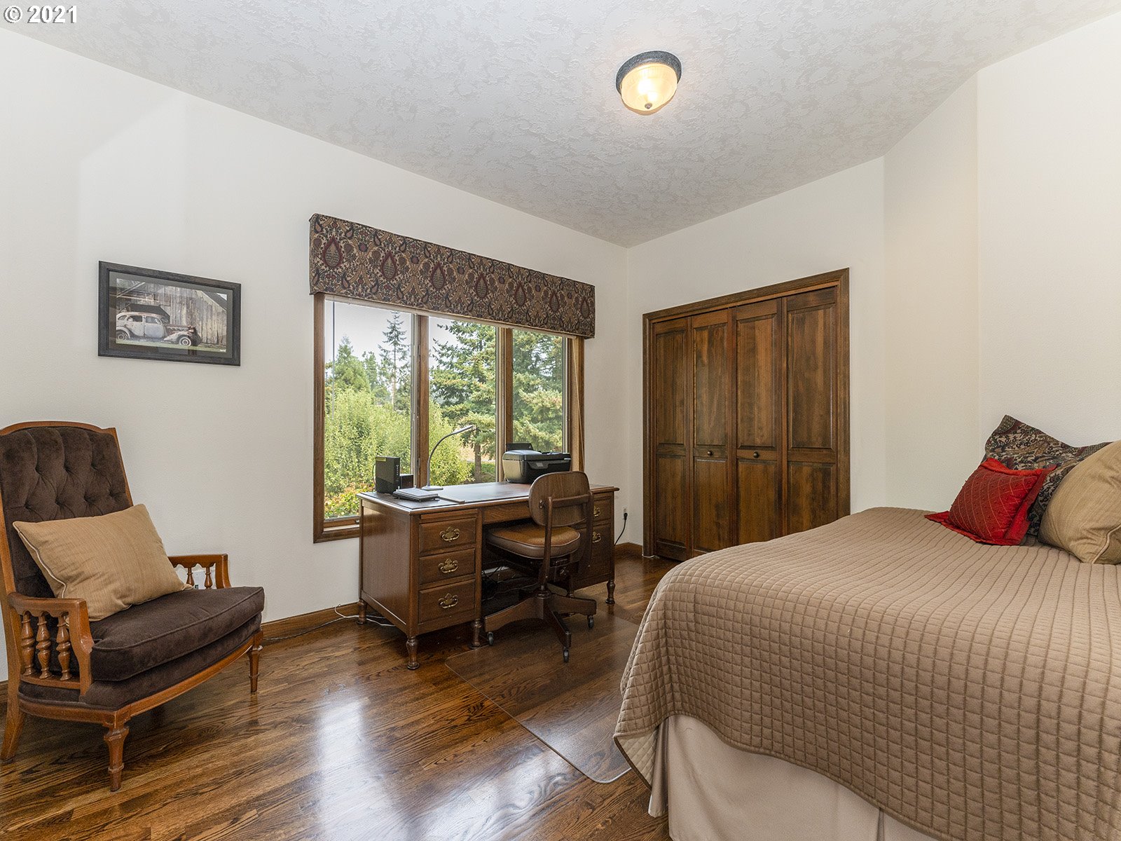 18350 Southwest Kramien Road Newberg, OR 97132 - Photo 17 of 31 a bedroom with a bed and wooden floor