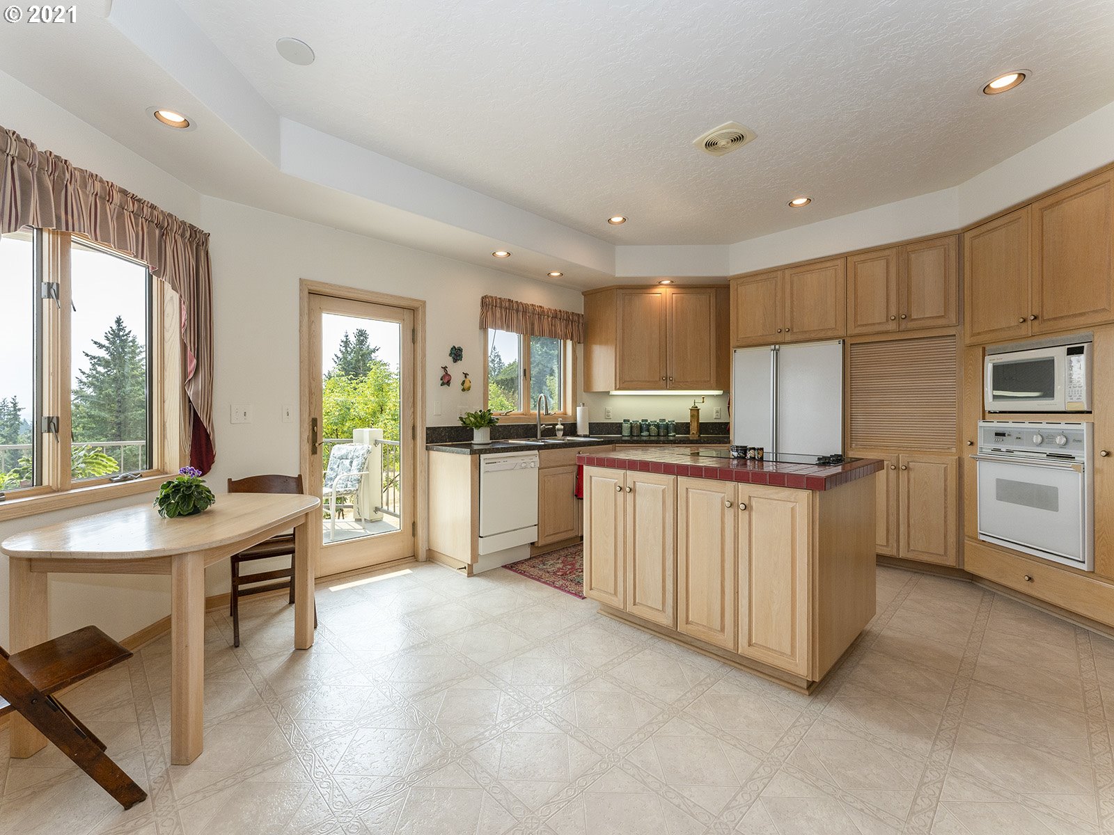 18350 Southwest Kramien Road Newberg, OR 97132 - Photo 7 of 31 a kitchen with white cabinets and refrigerator