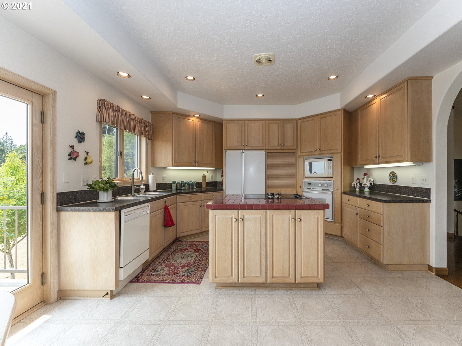 18350 Southwest Kramien Road Newberg, OR 97132 - Photo 8 of 31 a kitchen with stainless steel appliances granite countertop a stove top oven a sink a counter top space and cabinets