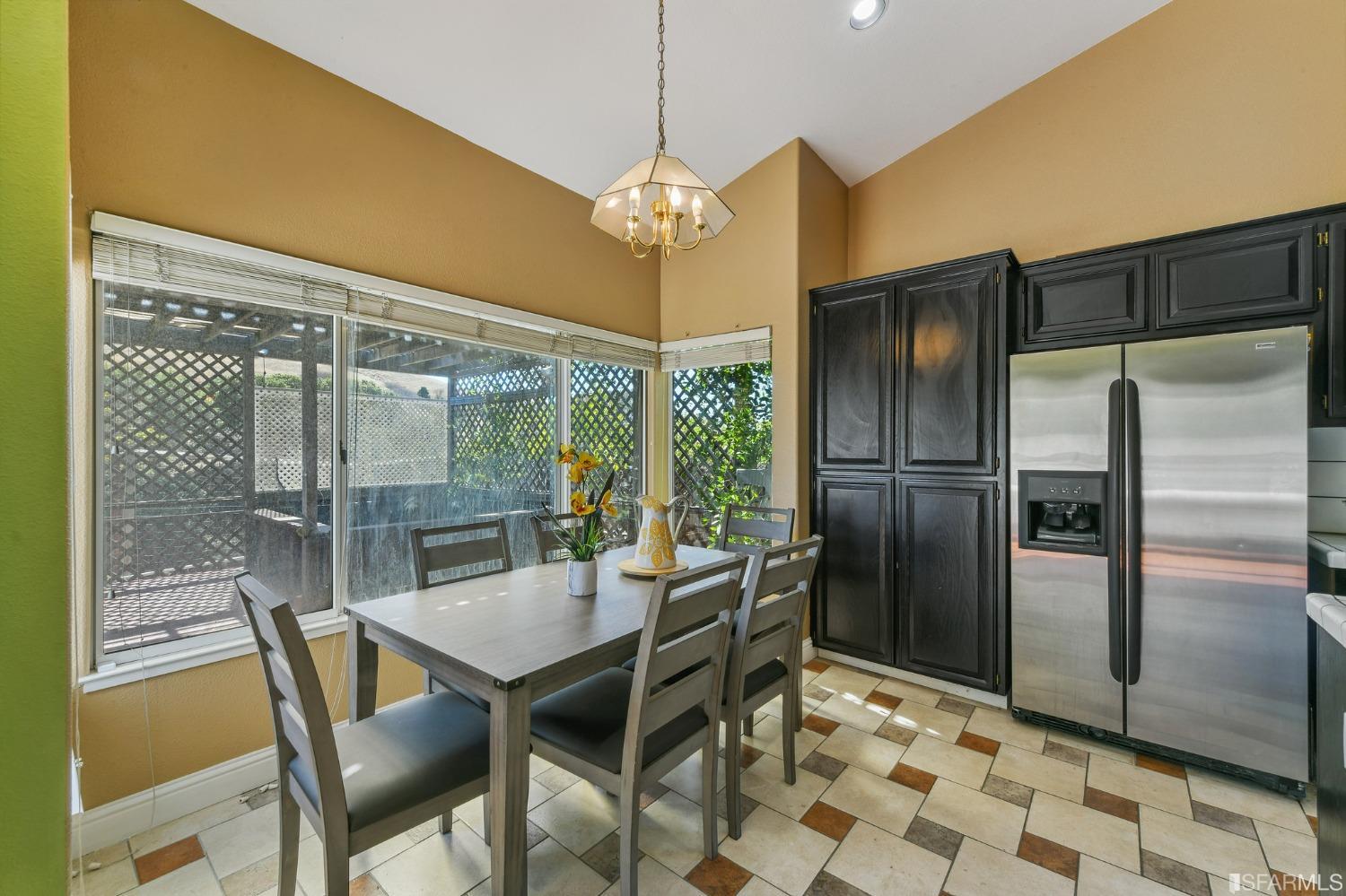 698 Turquoise Drive Hercules, CA 94547 - Photo 21 of 50 a dining room with stainless steel appliances granite countertop a table and chairs