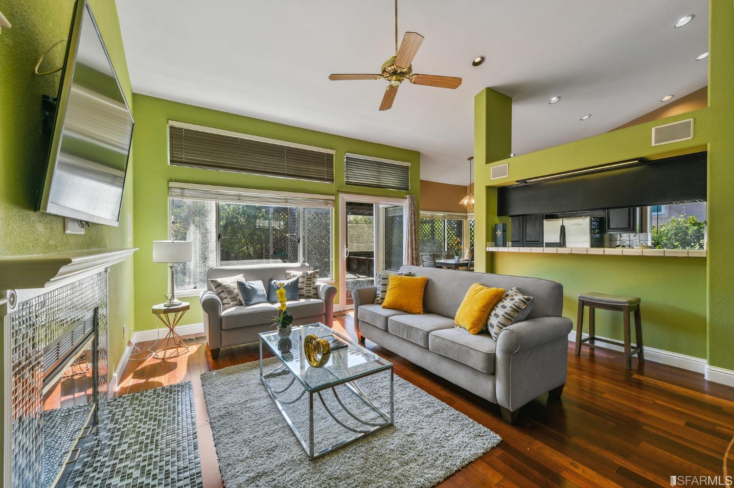 698 Turquoise Drive Hercules, CA 94547 - Photo 24 of 50 a living room with furniture wooden floor and a fireplace