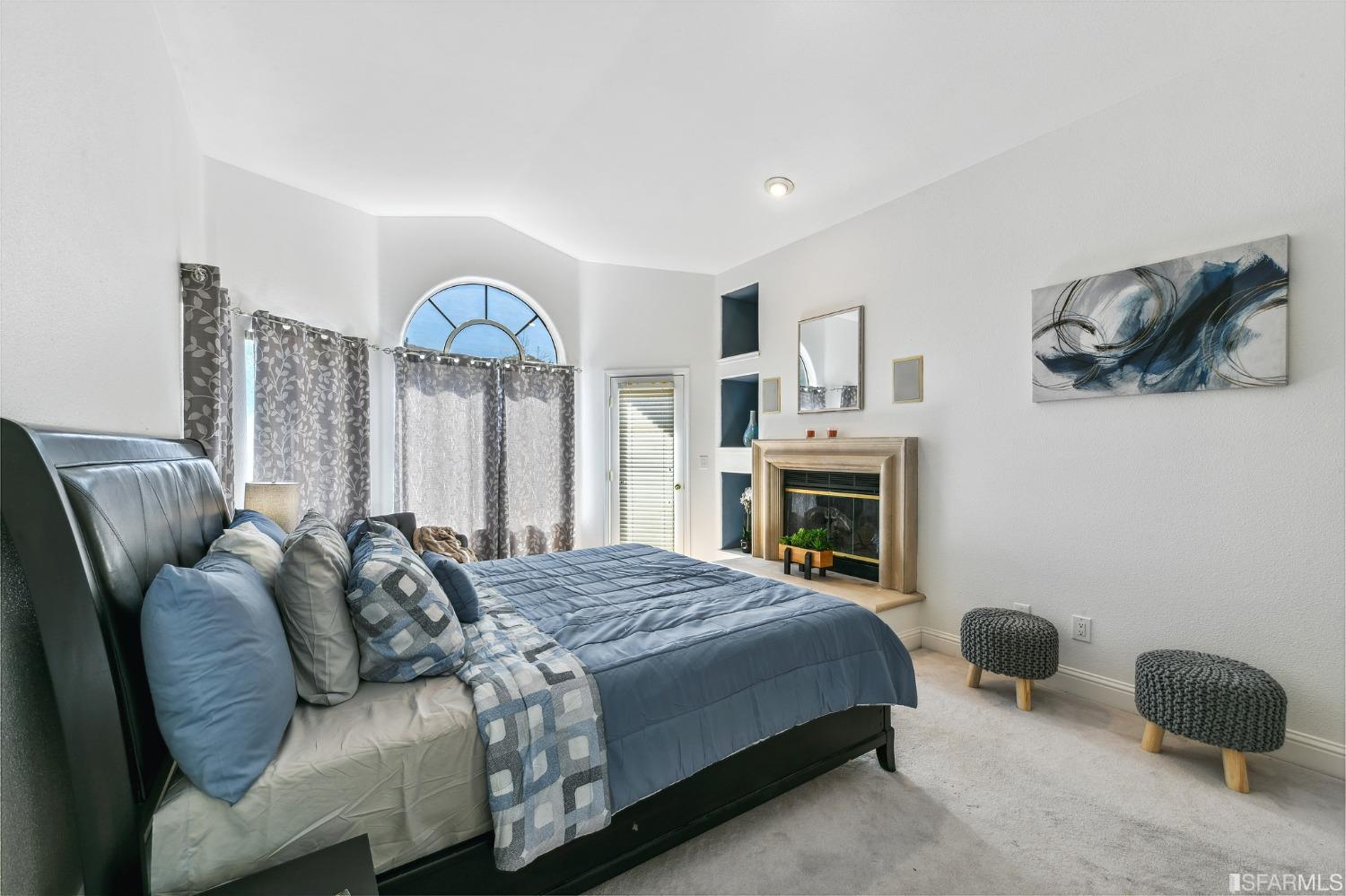 698 Turquoise Drive Hercules, CA 94547 - Photo 27 of 50 a bedroom with a bed and a fireplace