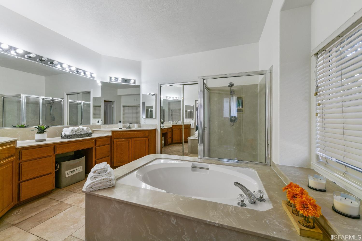 698 Turquoise Drive Hercules, CA 94547 - Photo 31 of 50 a bathroom with a tub a double vanity sink and mirror