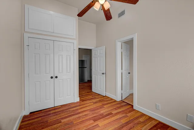 a view of a room with wooden floor