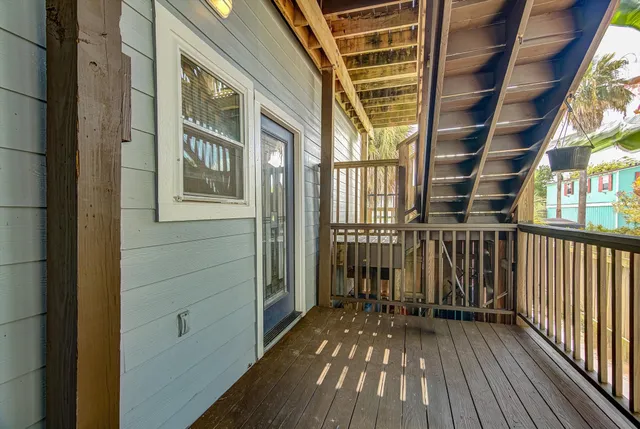 a view of balcony with wooden floor and fence