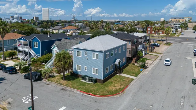 a aerial view of a house with a yard table and chairs