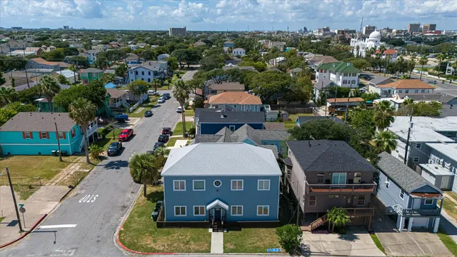 an aerial view of a house with garden space and lake view
