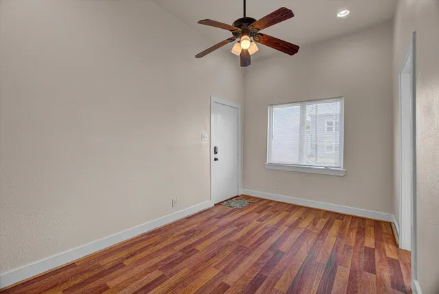wooden floor in an empty room with a window