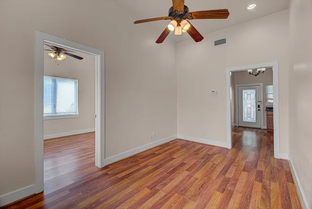 wooden floor in an empty room with a window