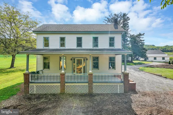 a front view of a house with a yard and a garden