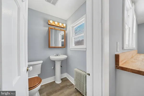 a bathroom with a toilet sink and mirror
