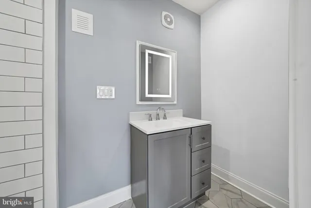 a bathroom with a sink a vanity and a mirror