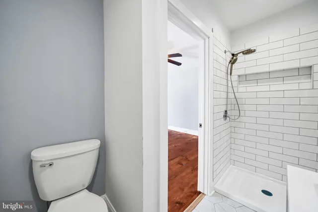 a bathroom with a toilet and shower