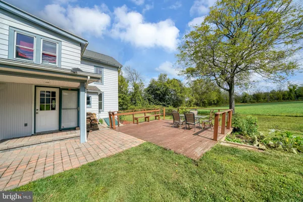 a view of a house with backyard porch and sitting area