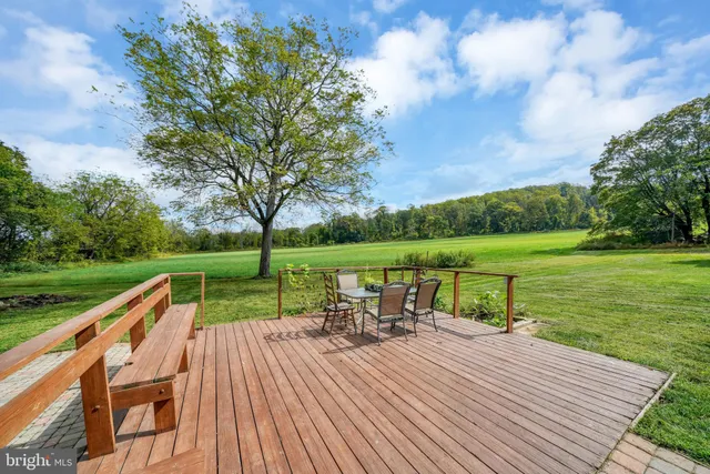 a view of a deck with chairs and a yard