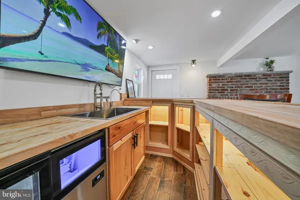 a kitchen with stainless steel appliances granite countertop a sink and wooden cabinets