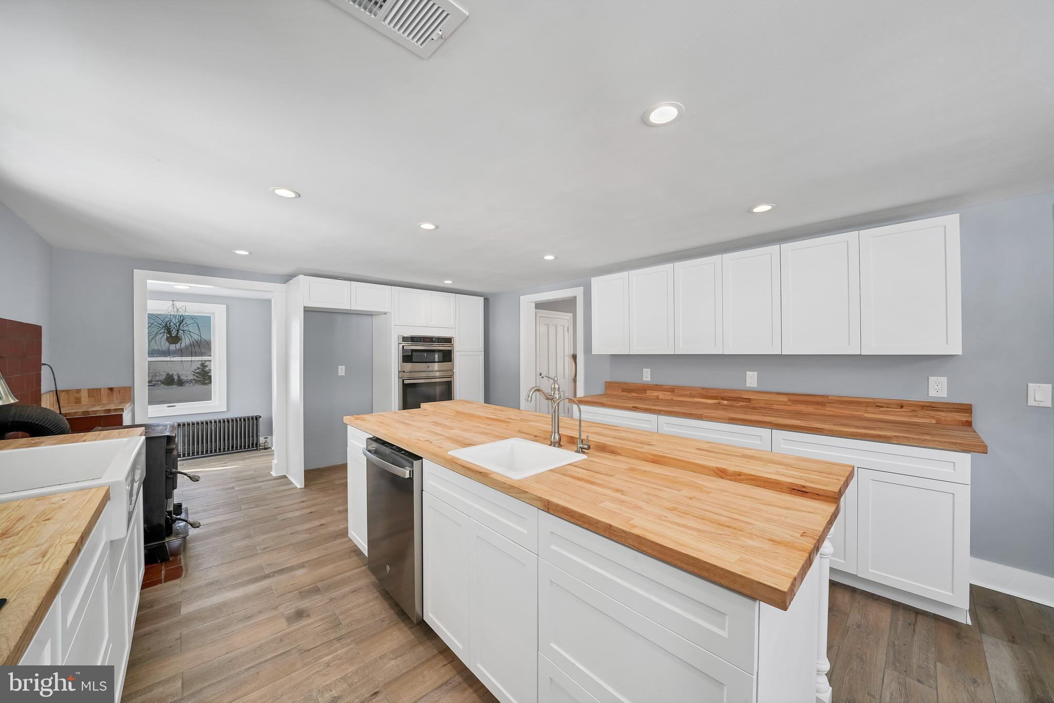 89 Asbury Broadway Road Asbury, NJ 08802 - Photo 4 of 49 a living room with stainless steel appliances granite countertop a kitchen island wooden floors and white cabinets