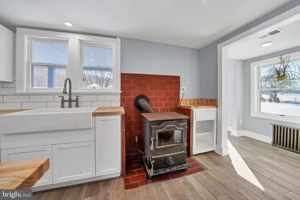 a view of kitchen and sink with wooden floor
