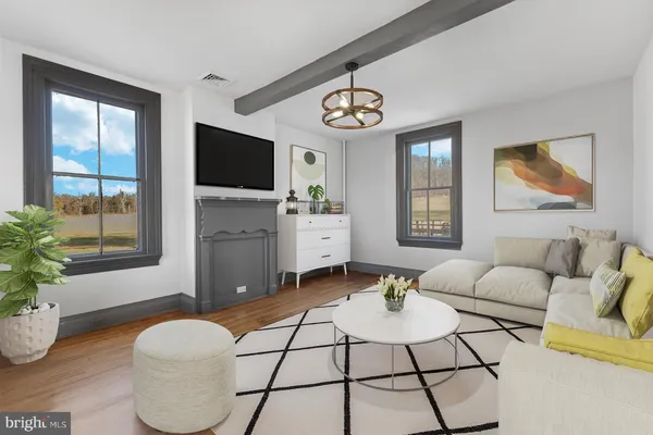 a living room with furniture a flat screen tv and a large window