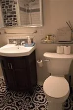 a bathroom with a sink toilet and a mirror