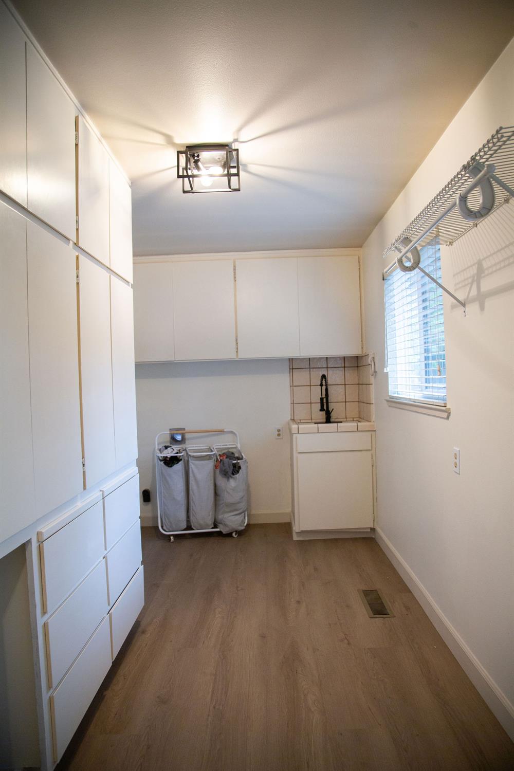 1208 Bristol Court Modesto, CA 95350 - Photo 13 of 40 laundry room, vinyl plank floor