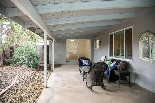 a view of a backyard with swimming pool and outdoor seating