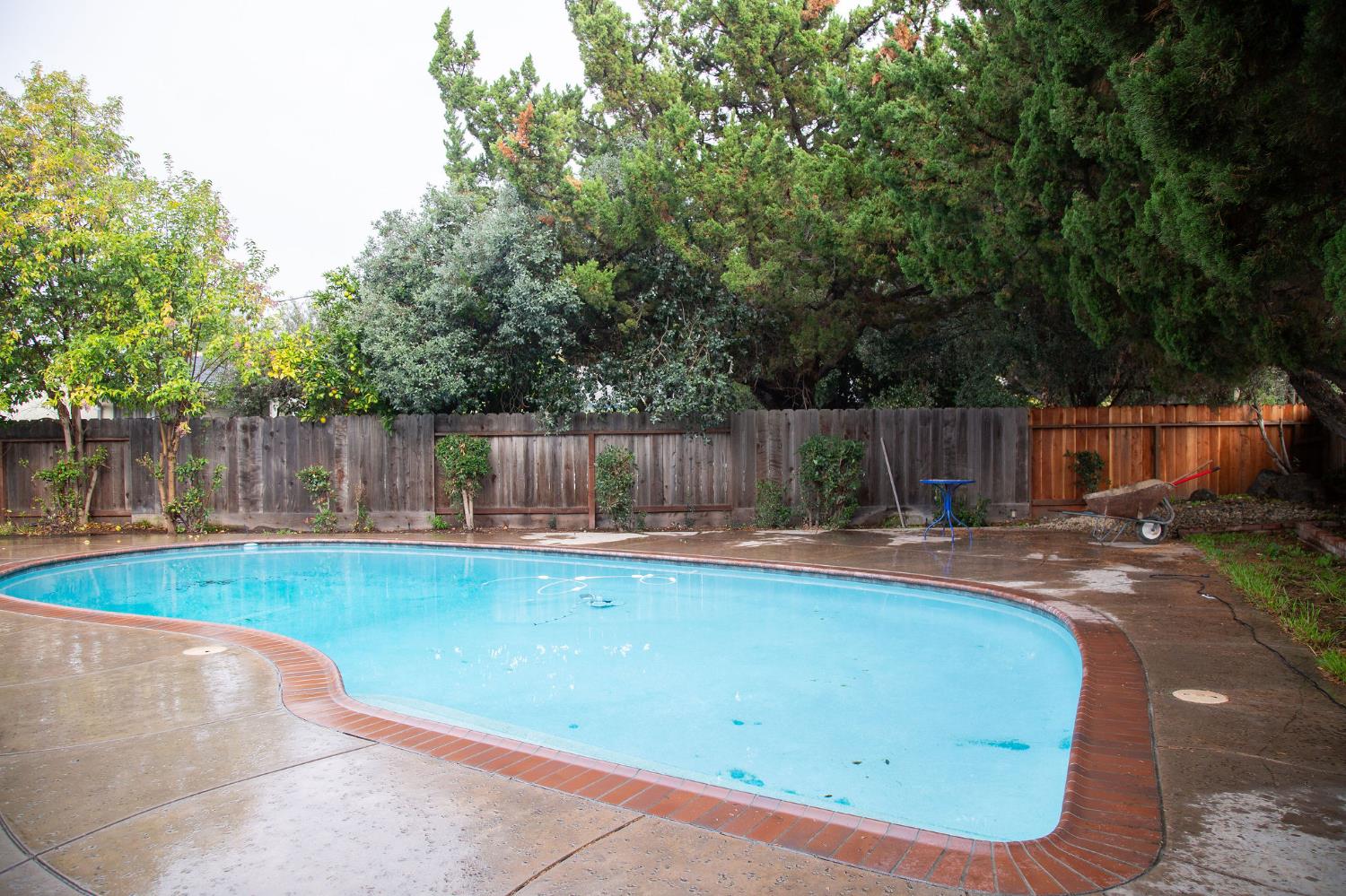 1208 Bristol Court Modesto, CA 95350 - Photo 35 of 40 view of salt water swimming pool featuring a fenced backyard and a patio area