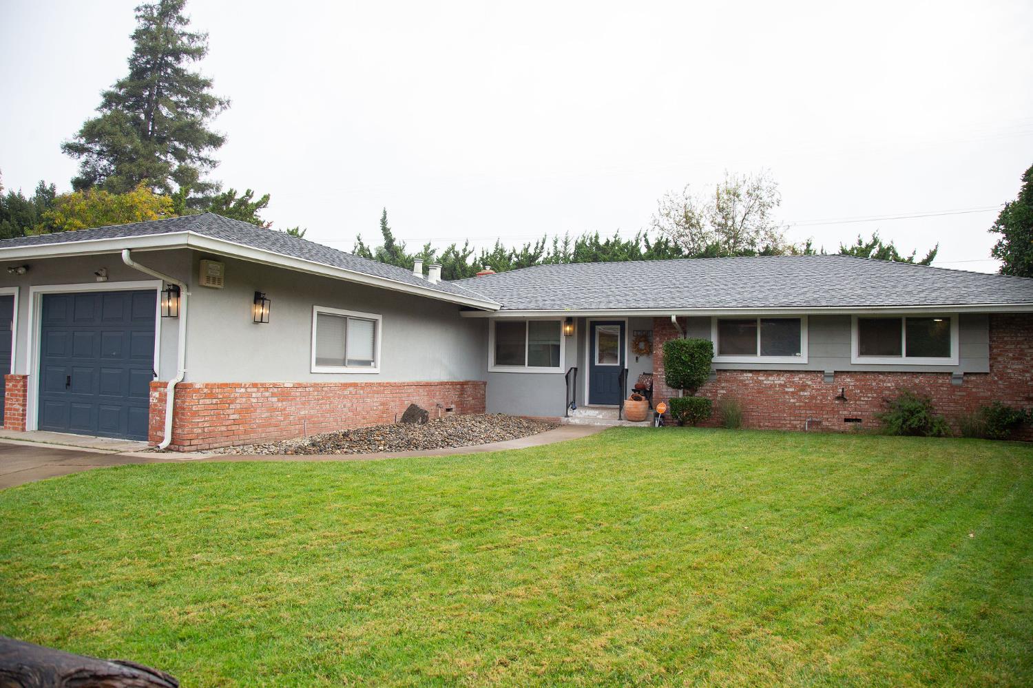 1208 Bristol Court Modesto, CA 95350 - Photo 5 of 40 ranch-style home featuring a front lawn, brick siding, and an attached garage
