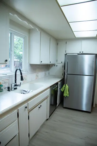 a kitchen with a refrigerator and a sink