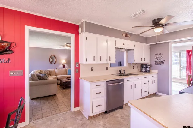a kitchen with a sink stove and cabinets