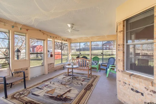 a living room with furniture large window and table