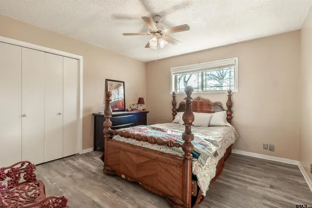 a bedroom with a bed and a chandelier