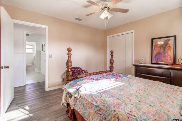 a bedroom with a bed and wooden floor