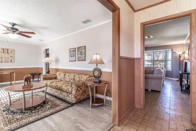 a living room with furniture and a lamp