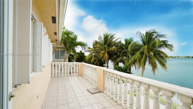a balcony with view of palm trees