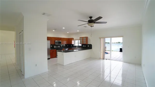 a view of a kitchen with a sink and a refrigerator