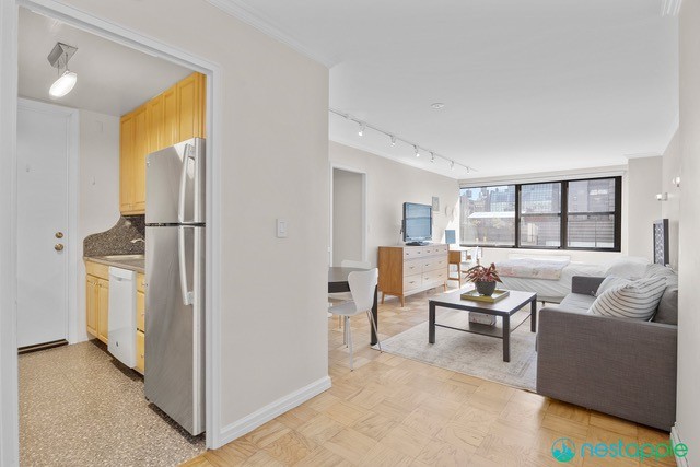 7 East 14th Street, Unit 1009 Manhattan, NY 10003 - Photo 11 of 13 a living room with furniture and a window