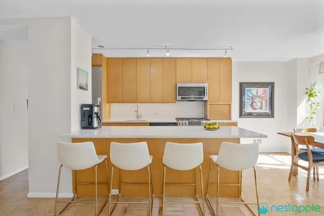 a kitchen with a dining table chairs and window
