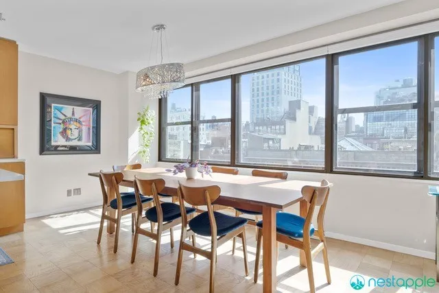 a view of a dining room with furniture large windows and wooden floor