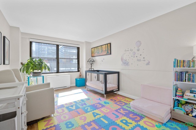 7 East 14th Street, Unit 1009 Manhattan, NY 10003 - Photo 6 of 13 a bedroom with furniture and a rug