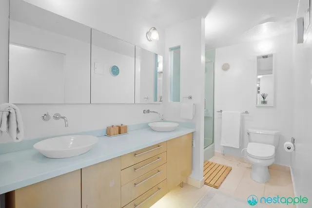 a bathroom with a granite countertop sink toilet and shower