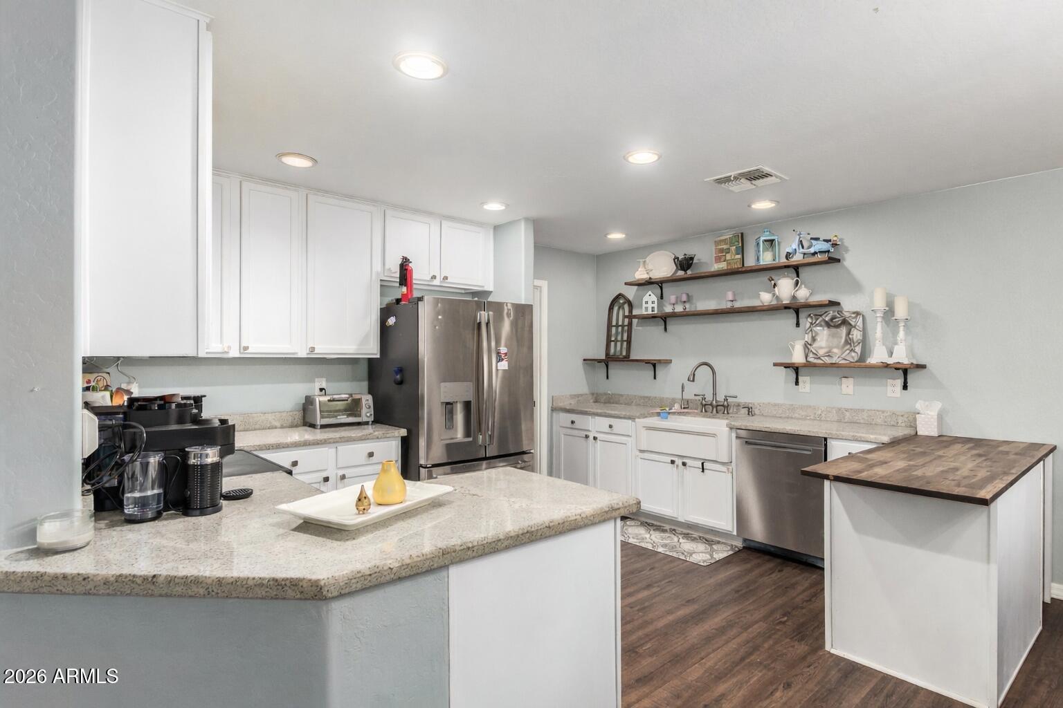 907 South Henry Lane Gilbert, AZ 85296 - Photo 3 of 25 a kitchen with kitchen island granite countertop a sink appliances and cabinets