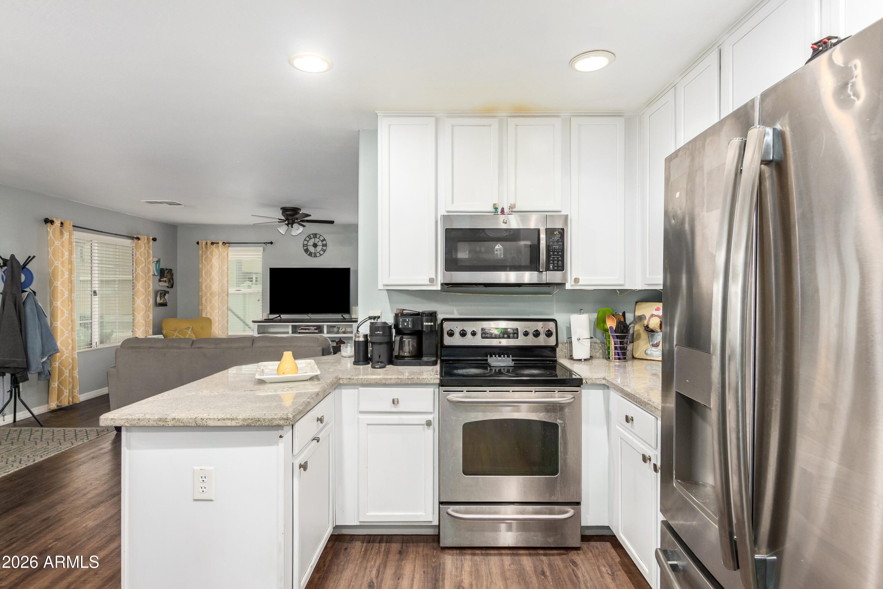 907 South Henry Lane Gilbert, AZ 85296 - Photo 10 of 25 a kitchen with stainless steel appliances a stove microwave and refrigerator