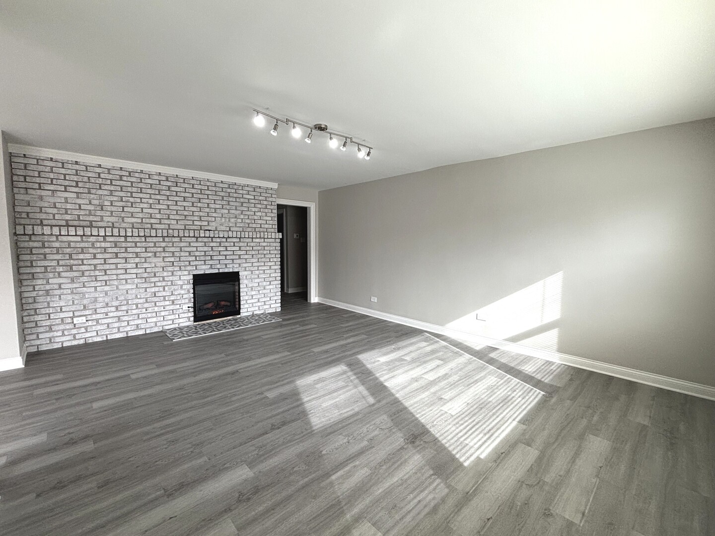17092 Lincoln Street Hazel Crest, IL 60429 - Photo 3 of 20 wooden floor in an empty room with a fireplace