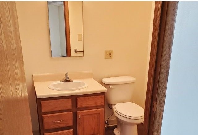 208 West State Street Huntington, IN 46750 - Photo 12 of 12 a bathroom with a sink a toilet and a mirror